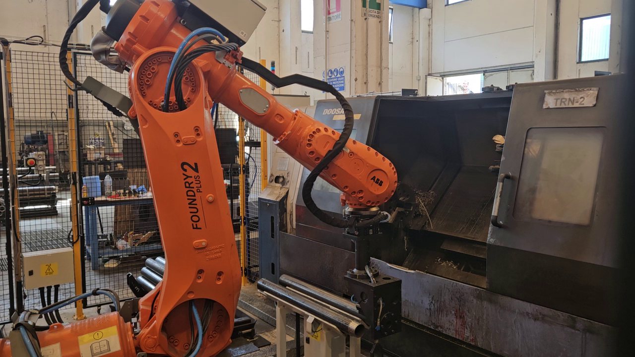 Robot ABB Foundry Plus 2 che carica un tornio con barre tubolari